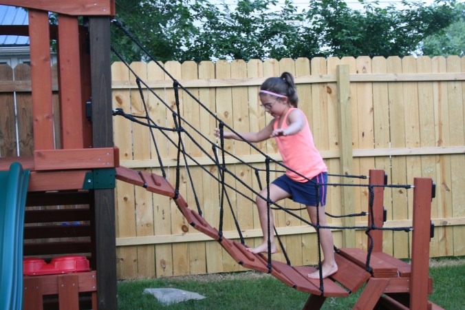 climbing the swinging bridge
