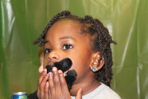 Nia putting on her mustache